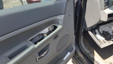 2001 Ford Crown Victoria - Photograph of a vehicle door panel interior, not a technical document.