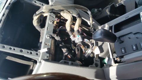 2001 Ford Crown Victoria - Photograph of a vehicle dash with exposed wiring harness behind it, not a technical document.