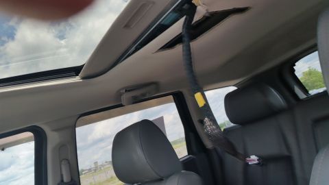 2001 Ford Crown Victoria - Photograph of a vehicle interior headliner with dangling wiring, not a technical document.