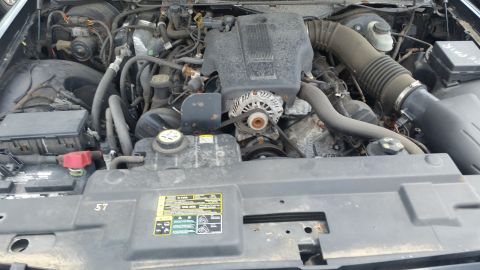 2001 Ford Crown Victoria - Photo of a Ford Crown Victoria engine bay showing the intake, alternator and battery.