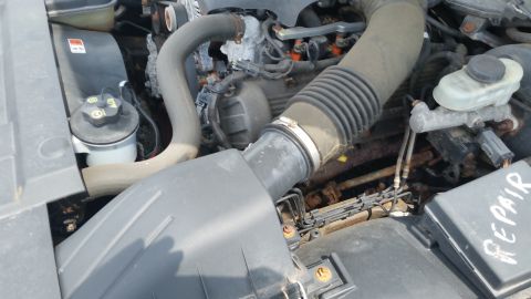 2001 Ford Crown Victoria - Photo of a Crown Victoria engine bay with air intake, brake master cylinder and a handwritten REPAIR note.