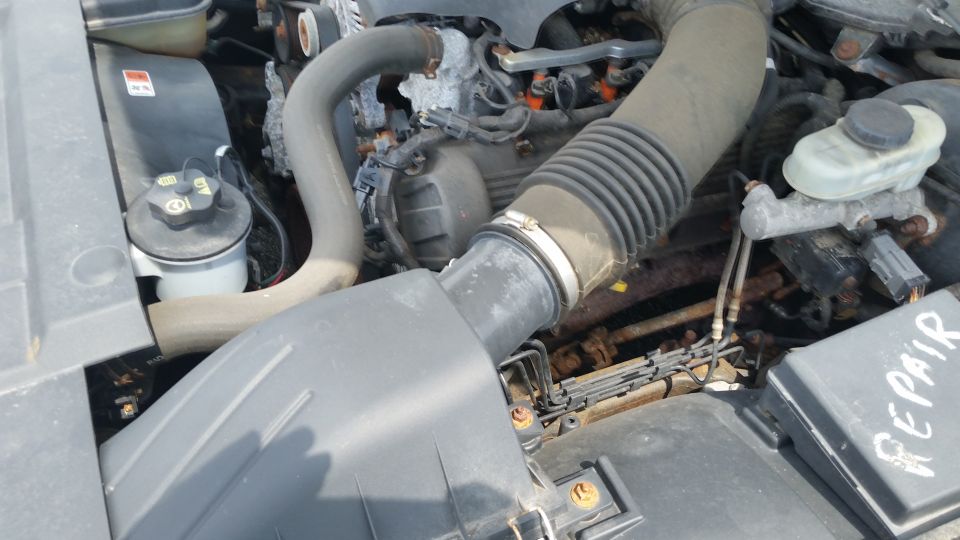 Engine bay with air intake duct, brake master cylinder and Repair marking