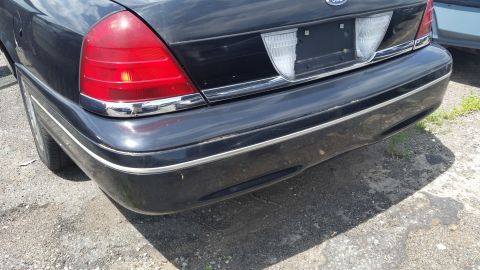 2001 Ford Crown Victoria - Photo of the rear bumper and taillight of a black Ford Crown Victoria.