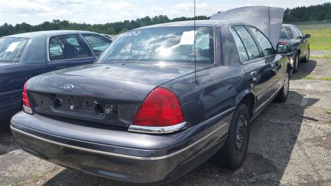 2001 Ford Crown Victoria - Photo of the rear of a gray Ford Crown Victoria with trunk emblems and reverse lights removed.