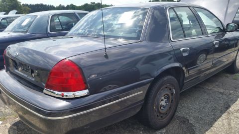 2001 Ford Crown Victoria - Photo of the rear three-quarter view of a dark gray Ford Crown Victoria sedan.