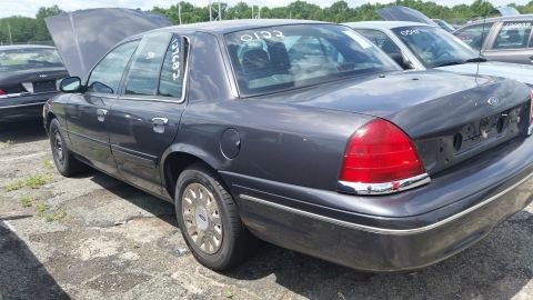 2001 Ford Crown Victoria - Photo of a gray Ford Crown Victoria sedan with open hood and windshield chalk markings.