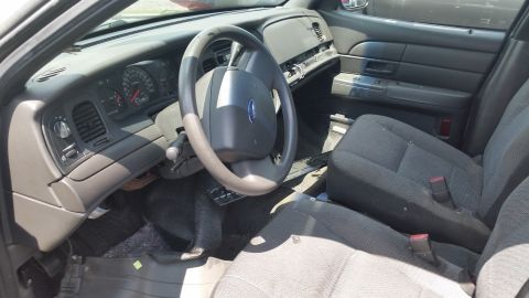 2001 Ford Crown Victoria - The interior of a 2001 Ford Crown Victoria, the dashboard and seats.