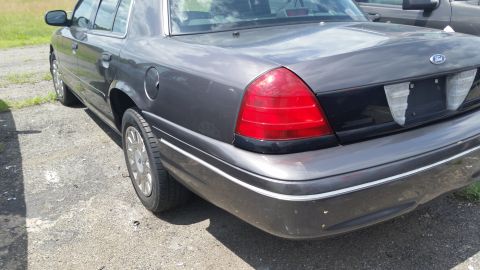 2001 Ford Crown Victoria - Rear view of a dark gray 2001 Ford Crown Victoria showing its taillight and trunk.