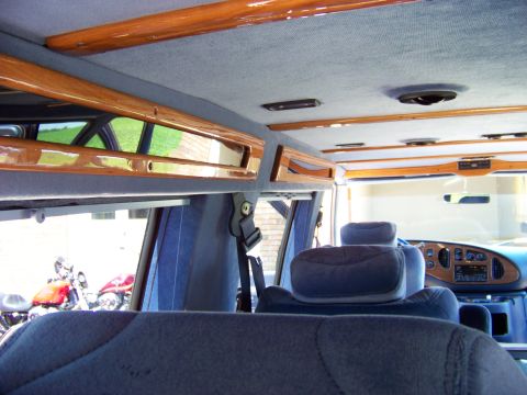 2000 Ford E150 - Interior of a 2000 Ford E150 van with custom wood trim and blue upholstery.