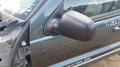 2001 Ford Crown Victoria - Side mirror and door panel of a green vehicle, with handwritten markings.
