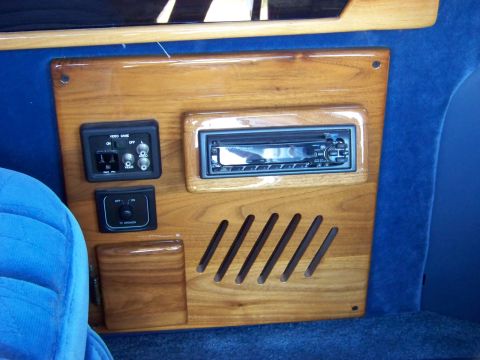 2000 Ford E150 - Close-up of an interior panel a car stereo, video game inputs, and a TV speaker control switch.
