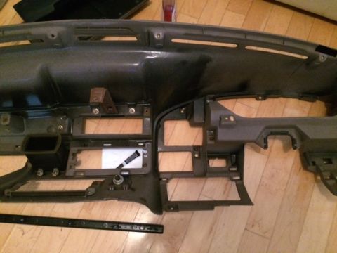 1994 Ford Bronco - Dashboard assembly removed from a vehicle, showing interior components and mounting points.