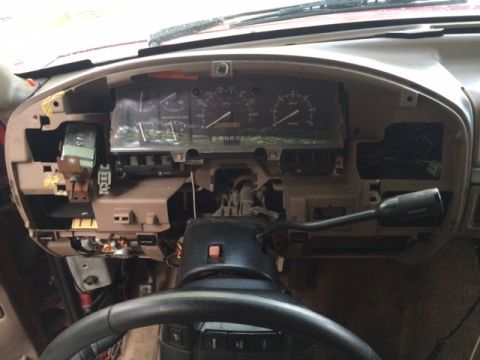 1994 Ford Bronco - The dashboard of a 1992 Ford Bronco is partially disassembled, revealing its internal components and wiring.