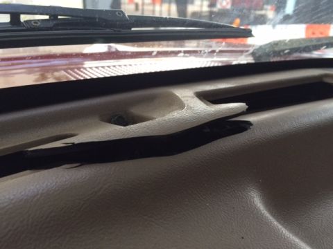 1994 Ford Bronco - Close-up view of a damaged dashboard interior, showing cracked plastic trim.
