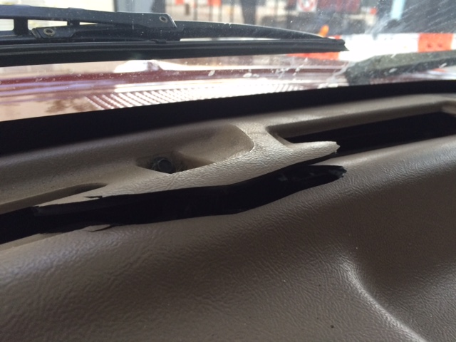 Dashboard with cracked plastic trim and visible damage