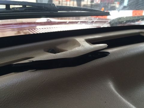 1994 Ford Bronco - Interior view of a 1994 Ford Bronco dashboard with visible damage to a trim piece.