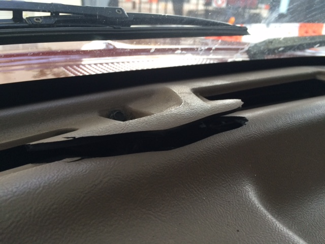 1994 Ford Bronco dashboard showing a cracked plastic trim piece near the windshield