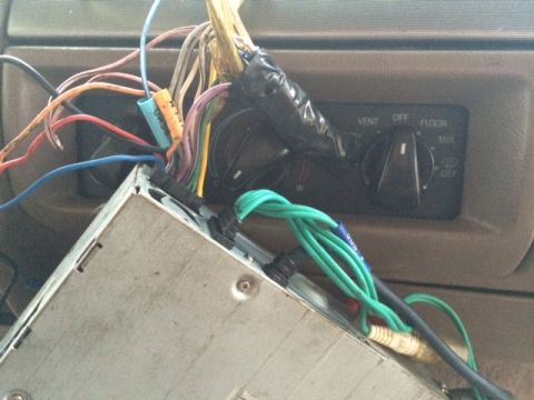 1994 Ford Bronco - Close-up of car stereo wiring and climate control knobs, including vent, off, floor, and mix settings.