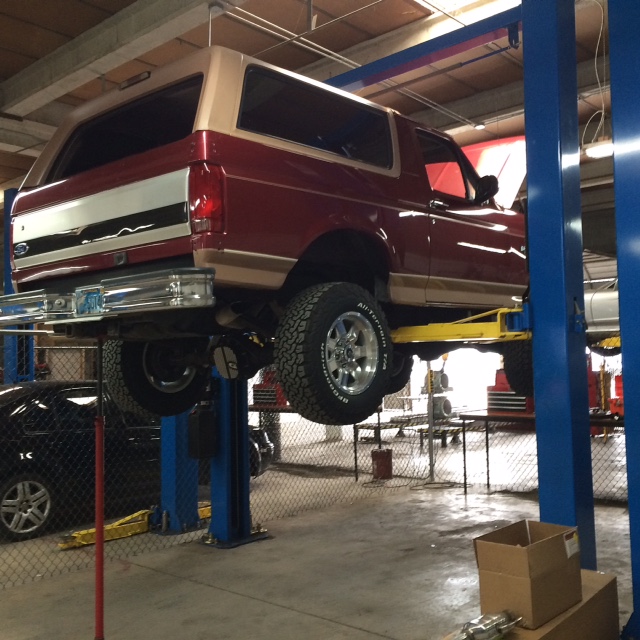 1994 Ford Bronco on a car lift, rear view.