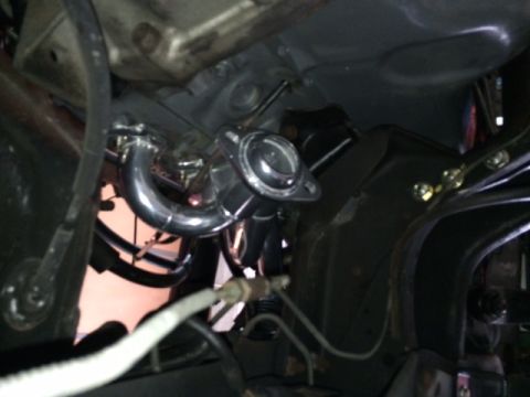 1994 Ford Bronco - A polished chrome exhaust manifold and wastegate are visible under the chassis of a vehicle. The components are connected to the engine blo…