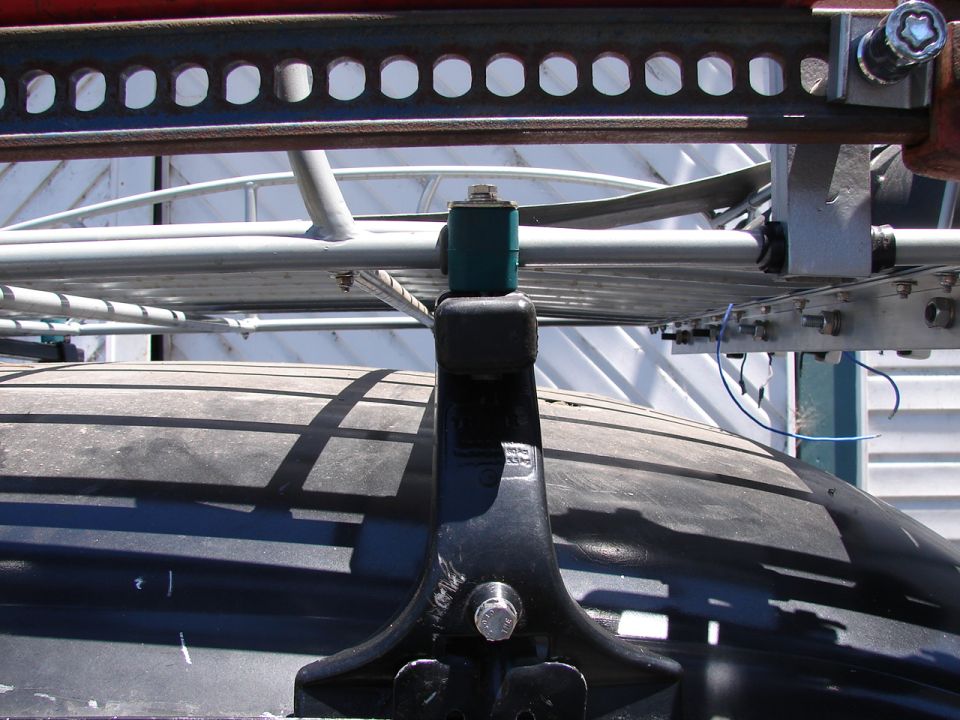 Close-up of a roof rack over a vehicle tire.