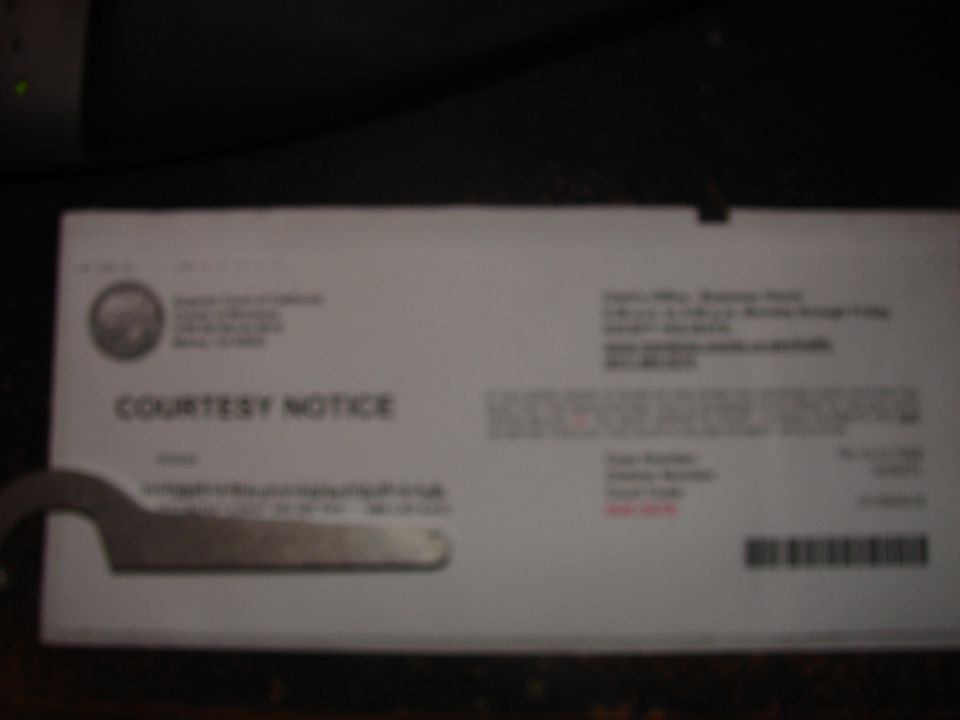Blurry courtesy notice with a metal tool in the corner.
