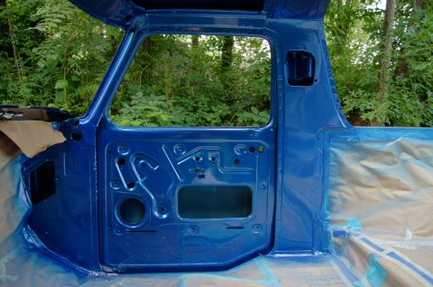 1979 Ford Bronco - A blue painted truck cab, likely a Ford Bronco part, is shown outdoors.