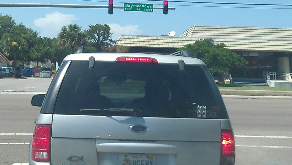 Rear view of a silver Ford SUV with a Florida license plate.