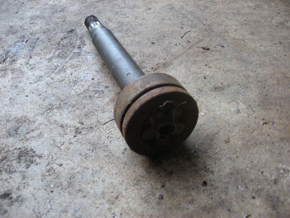Metal shaft with a rusted flange on concrete