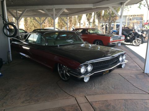 1968 Ford Mustang - Photo of a classic Cadillac under a carport, not a technical document.