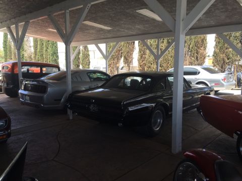 1968 Ford Mustang - Photo of a classic Mercury Cougar under a carport, not a technical document.