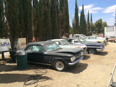 1968 Ford Mustang - Photograph of several classic project cars lined up outdoors, not a technical document.