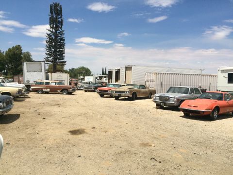1968 Ford Mustang - Photograph of a vehicle storage lot with classic cars, not a technical document.