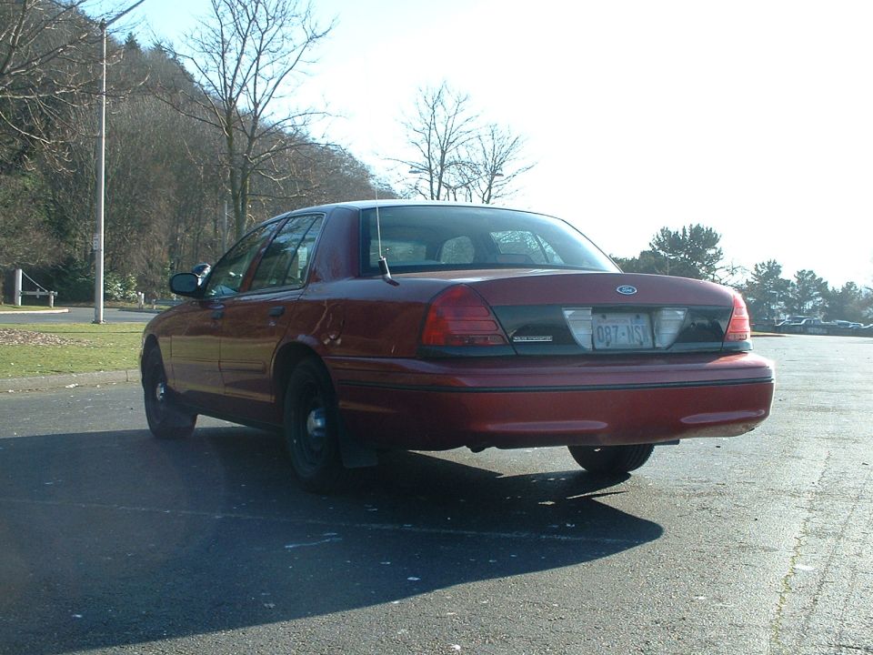 Red 1998 Ford Crown Victoria, rear view, parked on asphalt