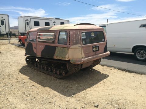 1968 Ford Mustang - Photograph of a camo-painted tracked over-snow carrier vehicle parked in a gravel lot.