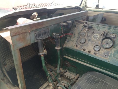 1968 Ford Mustang - Photograph of a worn green military-style vehicle interior showing the instrument panel and shift levers.