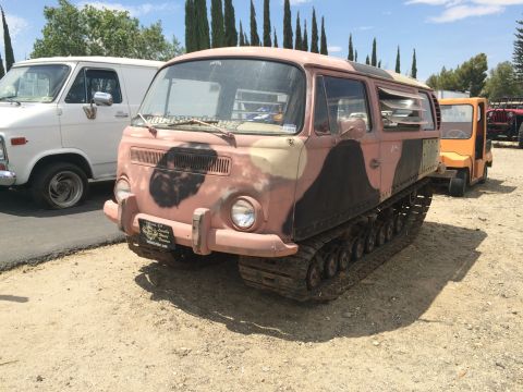 1968 Ford Mustang - Photograph of a pink-and-black camouflage tracked vehicle with a van body parked outdoors.