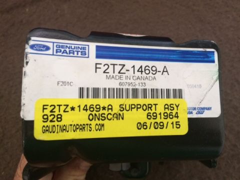 1994 Ford Bronco - A close-up of a Ford Genuine Parts label on a black vehicle part. The label shows part number F2TZ-1469-A and a yellow sticker with "F2TZ*1…
