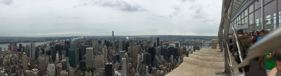 Panoramic photo of Manhattan skyline from an observation deck with visitors