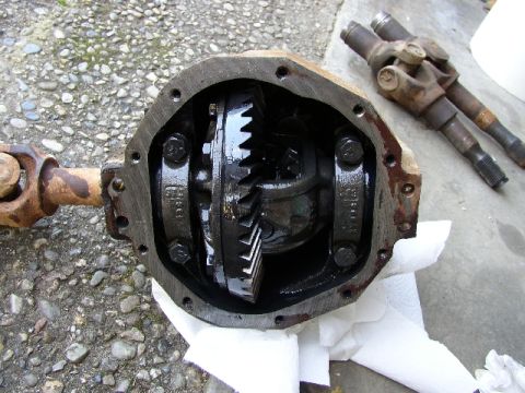 1989 Ford Bronco - This photo shows a disassembled differential and two axle shafts, likely for a vehicle repair or upgrade.