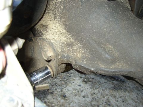 1989 Ford Bronco - A socket wrench is used on a dirty suspension part, with Supermotors.net branding visible.
