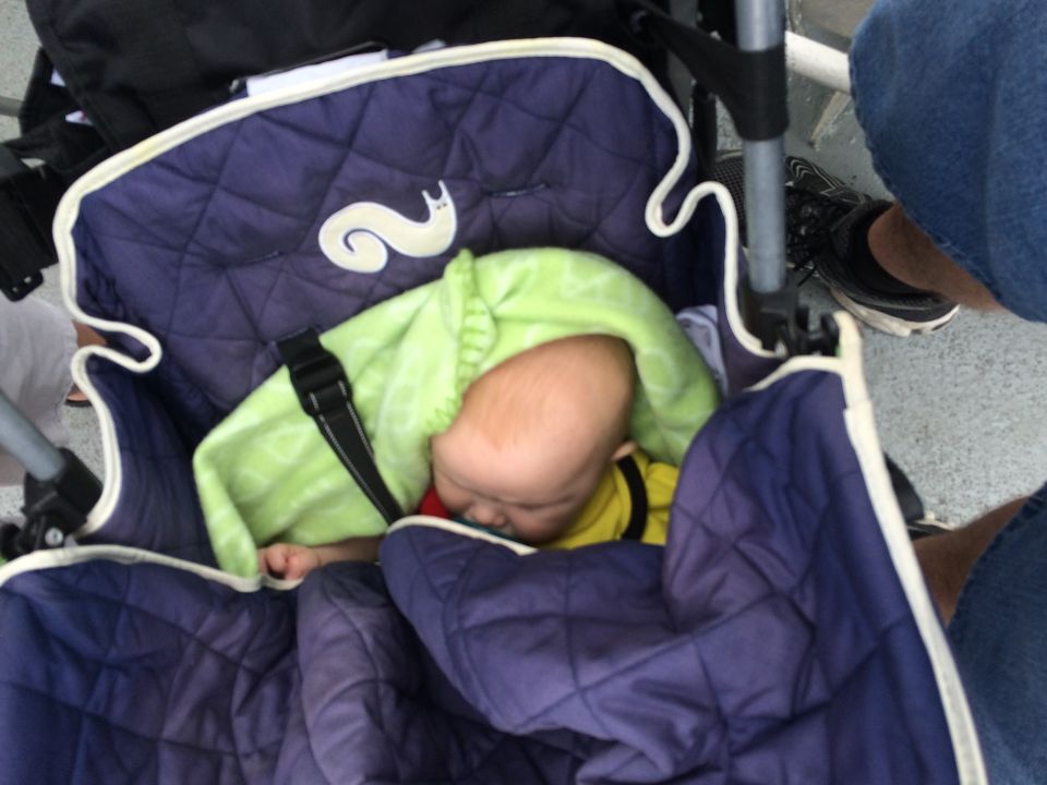 Sleeping baby bundled in a stroller outdoors