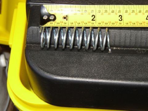 1989 Ford Bronco - Coil springs are shown being measured with a yellow tape measure.