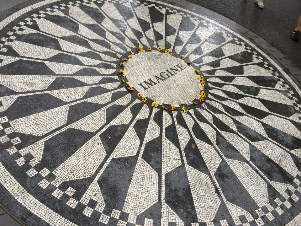 Imagine mosaic memorial in Central Park's Strawberry Fields with yellow flowers