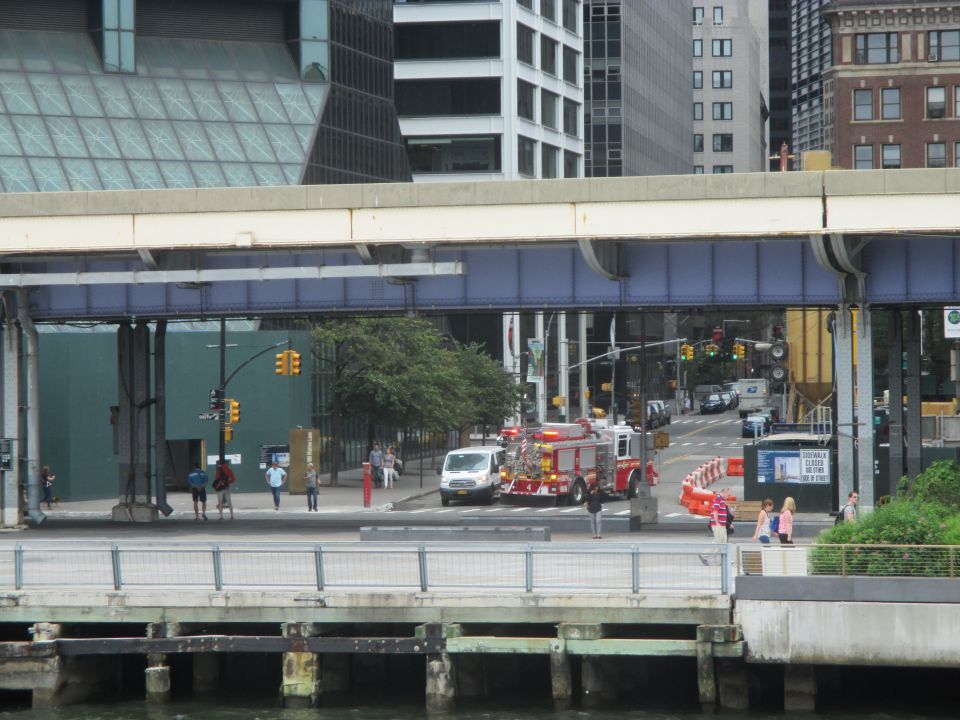 Fire truck and white van on a city street with buildings in background