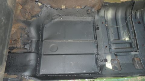 1972 Ford Ranchero - The floor pan of a vehicle has been repaired with new metal sections welded into place.
