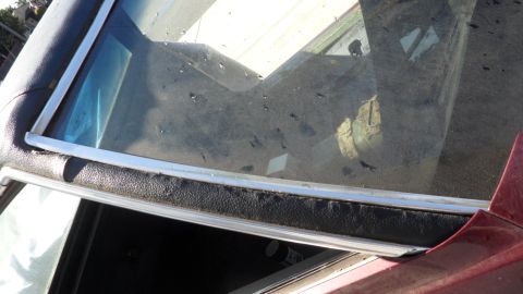 1972 Ford Ranchero - Interior view of a red 1972 Ford Ranchero, highlighting the cracked windshield and surrounding trim.