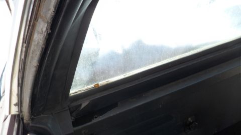 1972 Ford Ranchero - Interior view of a worn car window frame and seal.