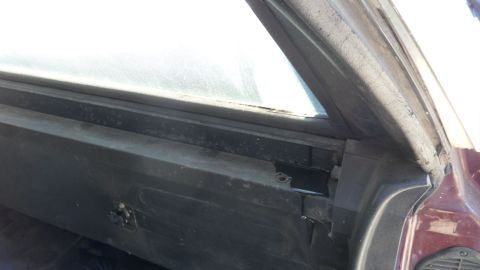 1972 Ford Ranchero - The interior door frame and window seal of a vehicle are shown in this close-up shot.