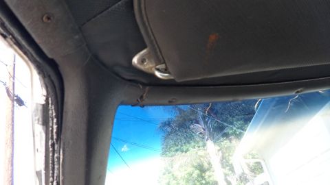 1972 Ford Ranchero - Close-up of the interior of a vehicle, focusing on the headliner and sun visor.